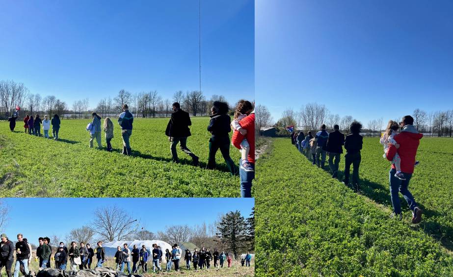 people walking around a spring meadow in a line